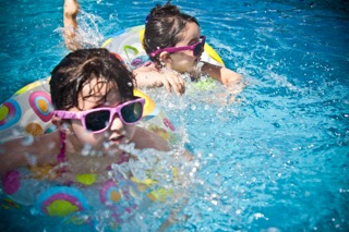 two kids swimming